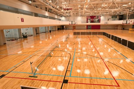 high and wide shot of courts 5 through 9. some of the courts are set up for volleyball